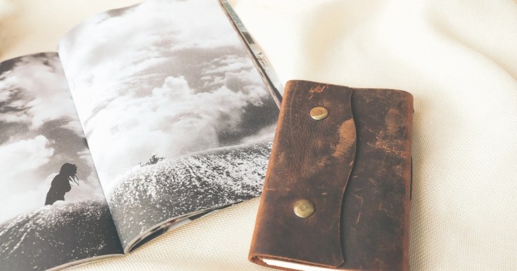 Photo of a leather journal and a magazine